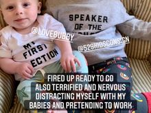 Baby boy’s shirt says “My First Election’” even though some of our men might read it differently.