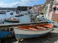 With the whimsical houses behind it, this boat was stored outside. But the local architecture also boasts some clever arched boat-storage shelter and corners.