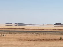 A mirage a small pool of water appears to be in the distance 