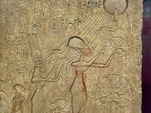 Ahkenhaten and his wife and family worshipping Aten, rhe sun god.