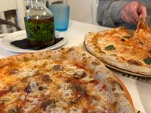 BOSCO pizza in foreground:  Mozzarella, tomato, carboncelli mushrooms, dotted with delicious morsels of sausage from Norcia.   This might be the very first time I've ever finished an entire pizza!!  In the back, the Margherita pizza.  The bottle contains slightly spicy olio santo, for me.