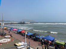 Surfers along the beach