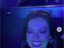 She's seated.  Even if she were standing, she would not block others.