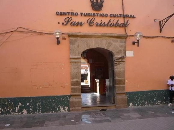 Not far from the Arch, you may want to check the San Cristóbal Cultural Center.  There are cafes and artesan shops along the interior plaza, and if any cultural events are going on in town, they likely will be announced on a sign just inside.
