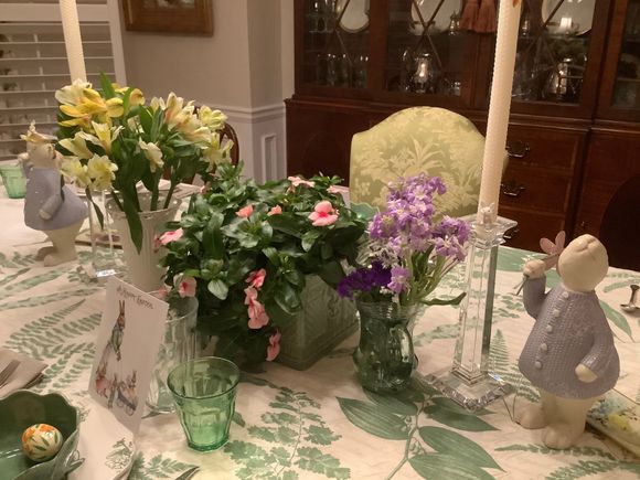 Yellow alstroemerias, pink vinca and lavender stock in a hodgepodge of containers and sizes.  Our Easter meal is breakfast this year.