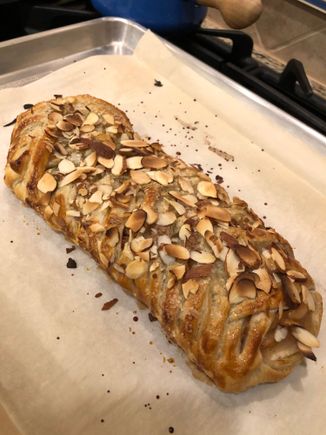 I made two of these with store bought puff pastry leftover in the freezer.  Sliced apples, honey, lemon juice and almond extract and cinnamon cooked on the stovetop for the filling with sliced toasted almonds sprinkled on before the faux lattice closure.  On the outside, egg wash, turbinado sugar and more almonds  on top.  A nice balance of sweet and tart, crunchy and soft.  I never peel apples because I think we should eat peels whenever possible. 