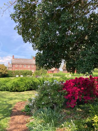 Glimpse of Shirley mansion from its garden 