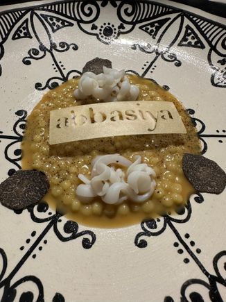 Fregola pasta (Sardinian). (I think I've written this before but so afraid of losing it now, as wifi is cutting out....). cooked in hen broth and topped with ribbons of calamari "pasta" and shaved black truffles..