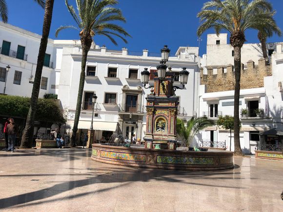 Main plaza of Vejer de la Frontera, with tiled fountain and surrounded by cafes and restaurants