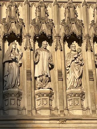 The person depicted in the middle of this frieze is Martin Luther King, I am not fibbing.