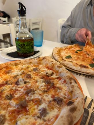 BOSCO pizza in foreground:  Mozzarella, tomato, carboncelli mushrooms, dotted with delicious morsels of sausage from Norcia.   This might be the very first time I've ever finished an entire pizza!!  In the back, the Margherita pizza.  The bottle contains slightly spicy olio santo, for me.