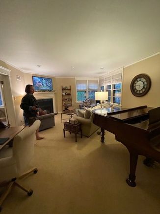 Living room. The wall behind the piano is all built-in bookshelves. 