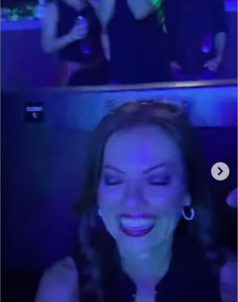 She's seated.  Even if she were standing, she would not block others.