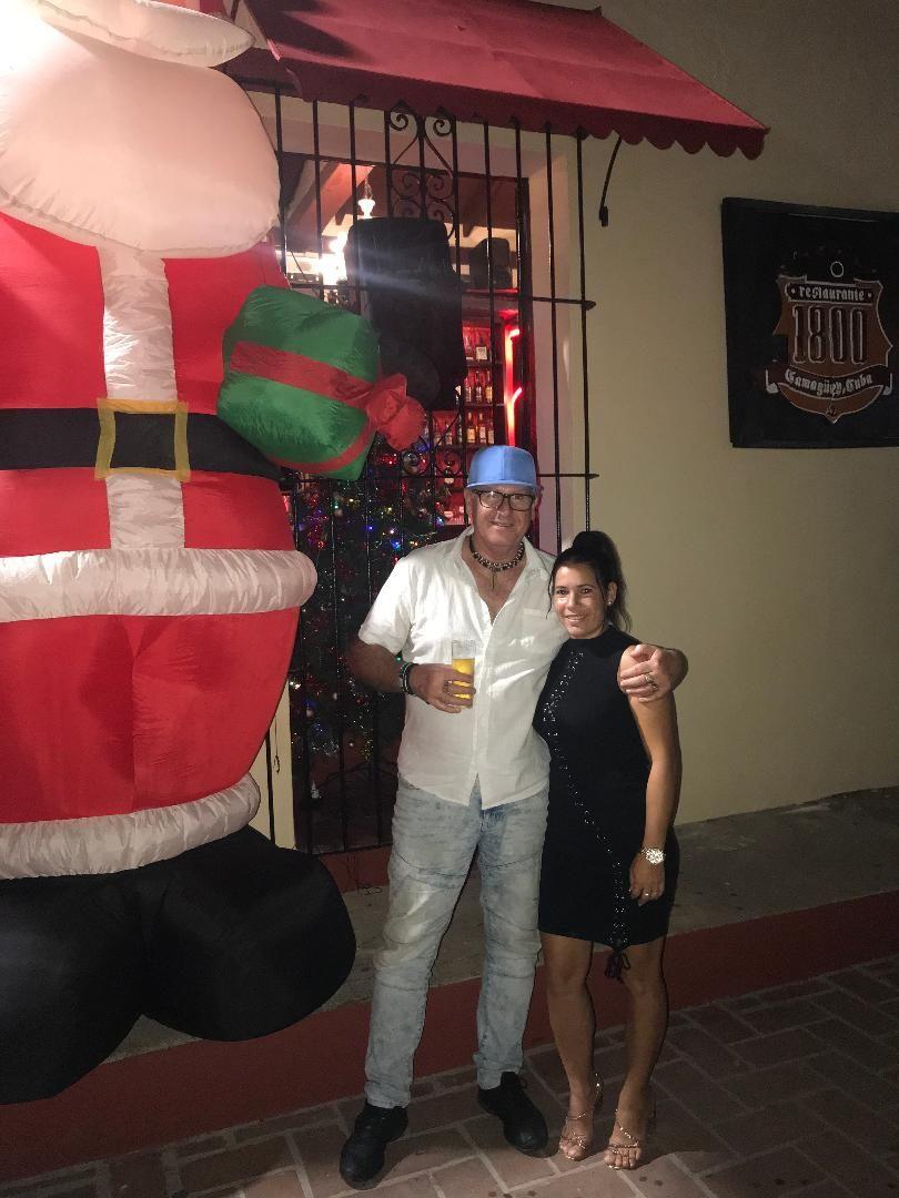 Yudith and I in front of the 2 story high Santa Claus out front of Restaurante 1800 in Camaguey city last Christmas. Great restaurant! Great times there always!