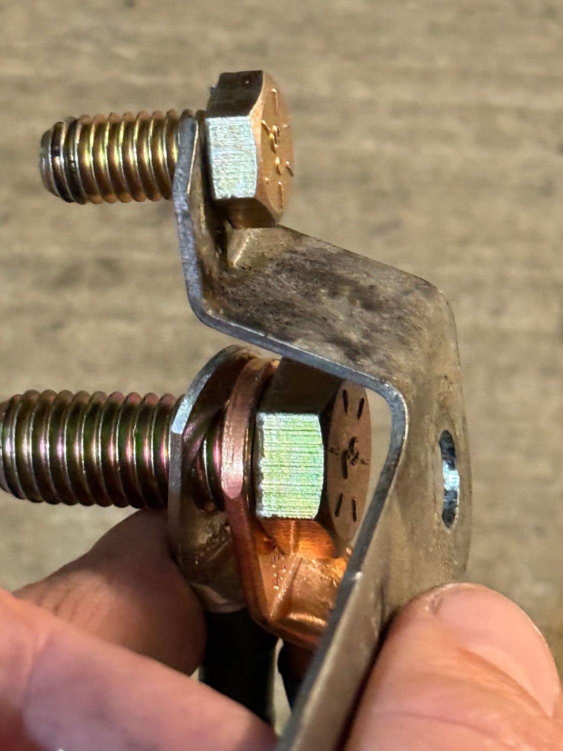 With top bolt in place, it would curve around the bottom bolt holding the negative cable.