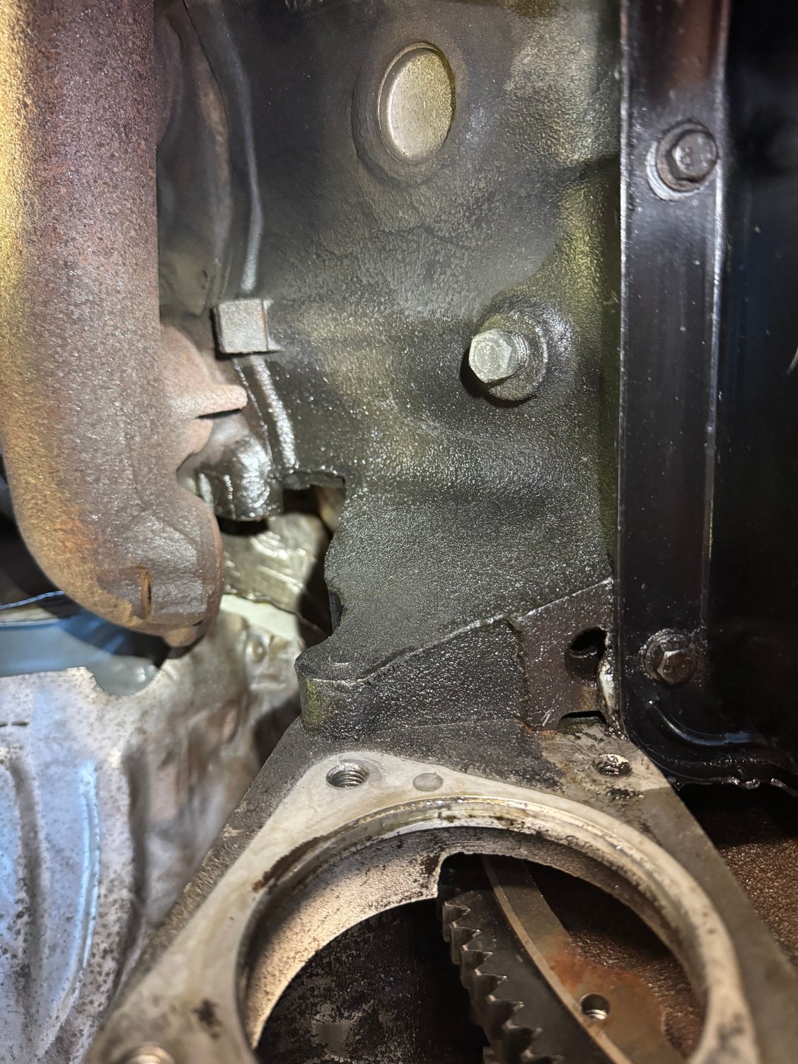 Cleaned up behind the old starter. She was a mess with all the crud seeping down through the weep hole from the leaks in the valley. 