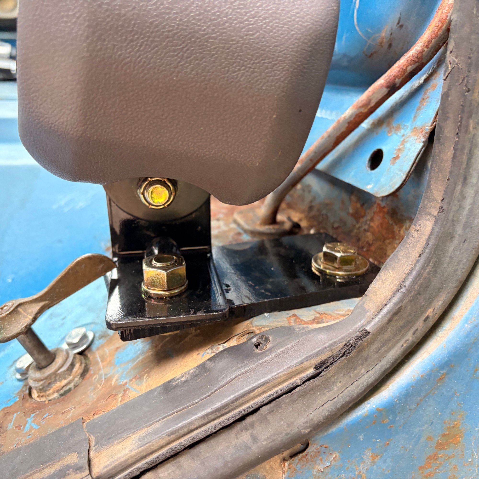 Update� I got them to fit. I ended up having to have a bracket made that would extend it out from the tank. I used quarter inch steel (Twice as thick as what the L bracket is that came with the universal seatbelt kit). The seat does fit between them because of the curvature of the bottom back. But it is tight. I�ve since taking it back out again because I�m fixing the mechanism that moves the bench seat on the track. I forgot to take pictures of it with the seat inside.