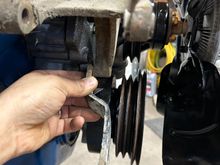 So then the alternator adjuster bracket needed straightened when it had been moved and stored at my buddies parents place it had got on this side and it bent the bracket. So I got the big hammer out, pulled my chunk railroad track out started beating on it to get it flatten straight again.