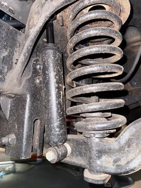 View of the front shock on the driver's side. The washers are easier to see. 