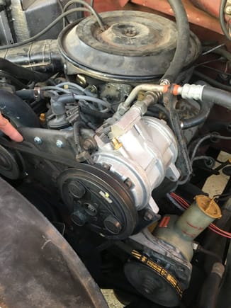 Pointing to the AC belt tensioner