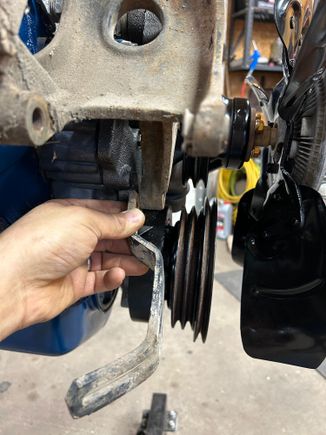 So then the alternator adjuster bracket needed straightened when it had been moved and stored at my buddies parents place it had got on this side and it bent the bracket. So I got the big hammer out, pulled my chunk railroad track out started beating on it to get it flatten straight again.