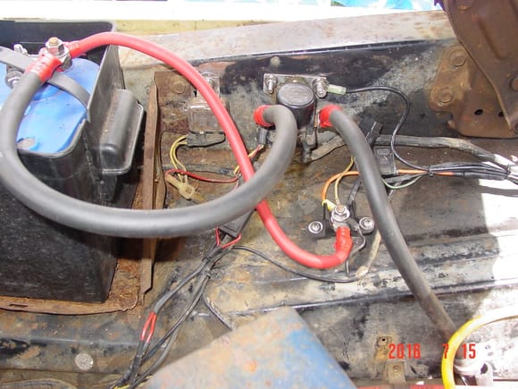In this pic you can see the large than original starter and positive cables. On the starter solnoind the black (ground) wire comes from the firewall. I later added a jumper wire to the horn relay mounting bolt too. This is very important if you have newly painted fenders.