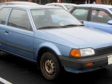Mazda 323 (not my actual vehicle)
Looks like mine. It was an ultra reliable car because it had nothing that could go wrong. It had the DX designation but I don't know why. The dealer installed the factory cruise control, no A/C, no power anything.
