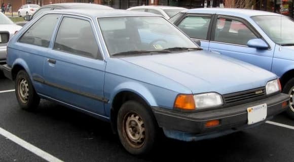 Mazda 323 (not my actual vehicle)
Looks like mine. It was an ultra reliable car because it had nothing that could go wrong. It had the DX designation but I don't know why. The dealer installed the factory cruise control, no A/C, no power anything.