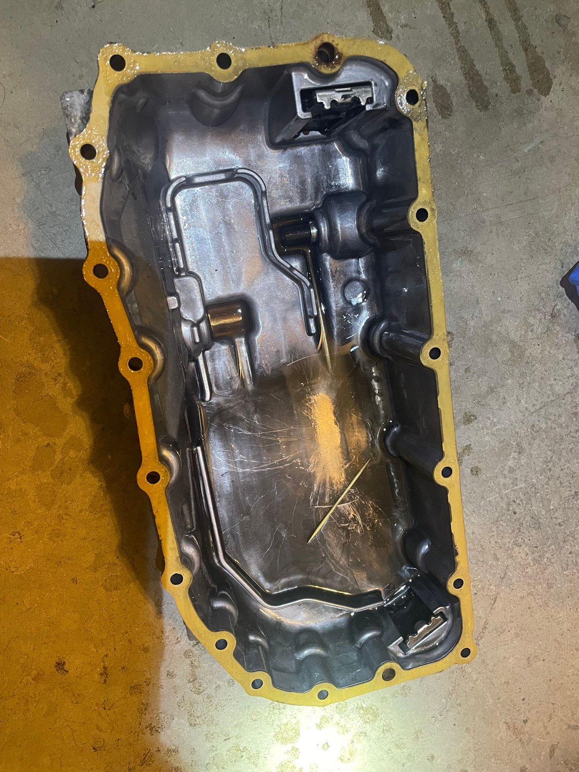 Inside of Transmission Oil pan, with old OEM gasket still attached.