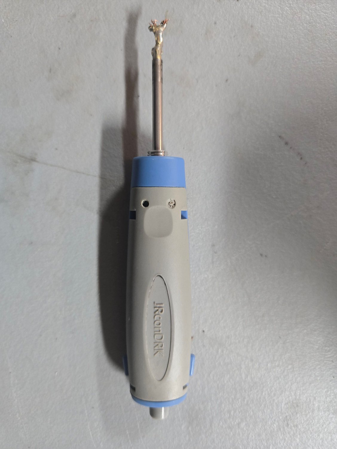 This is the tool over the connection pin.  Notice the button on the end of the tool which is now sticking out.  While keeping pressure on the tool when placed over the connector pin when its in the plastic connector, push the button.  This took me several tries to 