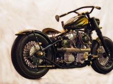 This bike is called the Brasshopper.  It is from a local builder and was in Easy rider a couple years ago.  All black and brass.