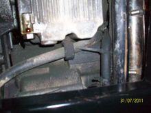 Modified 1 inch rubber coated hose clamp modified  to  fit center oil pan bolt. Put approx 5K miles with out clamp added clamp after finding it in tool box