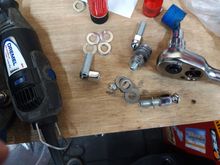 screws fitted and not fitted and showing the amount cut off by the washers in the center of the picture