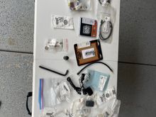 This is a bunch of random stuff, including electrical terminals, connectors, clutch adjustment tool for pre-M8 touring, some harnesses, big hex head tool for transmission fluid check stick. 