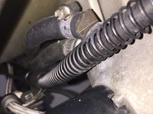 Hose runs underneath the oil filter adapter, then alongside the clutch cable, clamped in original location (-05 clamp, from aircraft spruce).