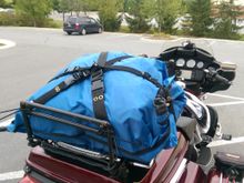 Undo three quick latch couplings and the bag is off!  They all pass through an anchor point on the bag, and I made a little loop with two snaps on it that they pass through.  Between them and the rear riser, the bag literally can't go anywhere.  And the whole thing comes off by cutting four ty-wraps that hold it down to the lighted Aerowing rack.