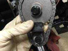 Use the cam locking tool, especially for assembly. It's a lot easier than having someone hold the rear brake. For timing components, better spend the extra 40 bucks. Clearly each sprocket has one bolt. The crank (bottom) is smaller and lower torque spec than the top (cam).