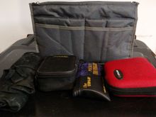 Large bag in my left saddlebag with rain gear. In the storage pouch I've got; tool roll, plug kit, mini compressor and first aid kit.