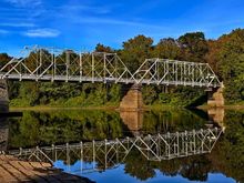 The Dingman's Ferry Bridge is privately owned a toll bridge across the Delaware River.  Pull up and hand the woman, standing between the lanes, two bucks and you are good to go.