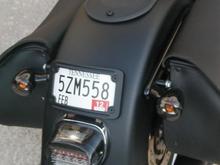 Flush mount Kuryakan license frame powder coated, Black smoke turn signal lens, Bright Ass LED (smoked) tail light, stock solo seat and fender bib. Powder coated the thumb screws for the bib.