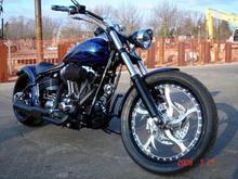 FRONT RIGHT
HHI Custom Trees - 5deg, Mid-Glide, Black
Powdercoated Lowers, Handlebar, &amp; Speedo Housing
H-D Headlight and Trimring w/ Powdercoated Shell
Kuryakyn Turn Signal Mirrors, Handgrips, Footpegs
21" Front Renegade Wheel with Metzler Tire
H-D 103" Engine w/ Heavy Breather Intake
Bassani Road Rage 2-1 Black Exhaust w/ Chrome End
