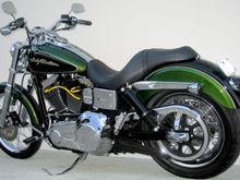 **Front End**
*H.D. 2006 Wide Glide 21" front wheel 
*H.D. Billet Fork Slider Dust Covers
*H.D. Chrome Lower Fork Sliders
*Kuryakyn Front Axle Nut Covers  
*H.D. 2008 Screamin Eagle Dyna front turn signal mounts 
*H.D. Classic Chrome Brake Caliper Insert 

**Hand Controls**
*H.D. Aileron Hand Grips
*H.D. Chrome Switch Cap Kit 
*Routed control wiring inside handle bars

**Tank**
*H.D. 2008 Screamin Eagle Dyna Gauges
*H.D. Smooth LED Fuel Gauge 
*Tank lift 1.60"

**Engine**
*H.D. Screamin Eagle Yellow 10mm spark plug wires 
*Home made spark plug wire supports
*Relocated horn 
*Installed banana jack on bottom of coil cover for battery tender

**Foot Controls**
*H.D. 2005 Forward control kit 
*H.D. 2006 Polished Stainless Steel Gear Shift Linkage *Removed the original shift lever without removing the primary
*H.D. 2007 Screamin Eagle Springer foot pegs 
*H.D. 2007 Screamin Eagle Dyna Polished Stainless Steel Footpeg Mounting Pins 
*Grinded down rear foot peg stops so pegs will tilt in more when in the up position

**Rear End**
*H.D. 2007 Street Glide Air Shocks 
*Modified lower belt guard
*H.D. Script Rear Axle Cover Kit 
*H.D. Tinted turn signal lenses 
*Painted turn signal reflector and internal housing flat black
*Custom Chrome lay down pyramid license plate mount *Trimmed license plate to fit inside mount
*Kuryakyn Deluxe Smoked Tail Light 
*Painted LED light face plate and inside of lens sides flat black