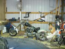 Trike 09
Yep smoke'em if you got 'em 
Now there you go go the rear fenders in. By the way yes that is a broom handle thru the wheel *LOL* we have to get the axles polished to fit yet. KC international help me out with these. Real nice 13.5 inch rear fenders on cut for right side drive to use on the left side of the bike and one uncut. Nice heavy metal should work out real nice. We plan to do a bit of cutting on these to style them up. Nice pieces for under 300 a pair to my door but KC is a bit of a crook on shipping to tell the truth but 13.5" fenders are not so easy to come by but I just had to have them 300 tires ya know !!