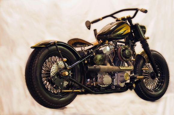 This bike is called the Brasshopper.  It is from a local builder and was in Easy rider a couple years ago.  All black and brass.