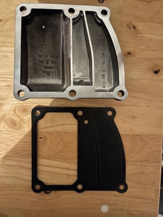 This is the stock cover and stock gasket, the crankcase portion (on the right) is completely sealed off with the stock cover/gasket.  The Trask cover and new gasket opens this area up with a one way reed valve to allow it to vent. 