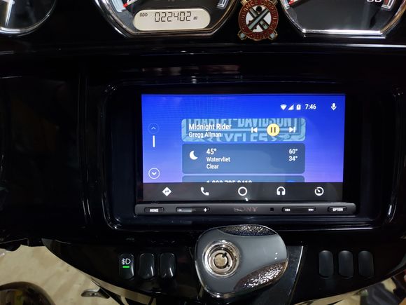 Android Auto's main screen: top card is the music source, middle is weather and the bottom (mostly hidden) card shows the last call made.