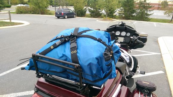 Undo three quick latch couplings and the bag is off!  They all pass through an anchor point on the bag, and I made a little loop with two snaps on it that they pass through.  Between them and the rear riser, the bag literally can't go anywhere.  And the whole thing comes off by cutting four ty-wraps that hold it down to the lighted Aerowing rack.