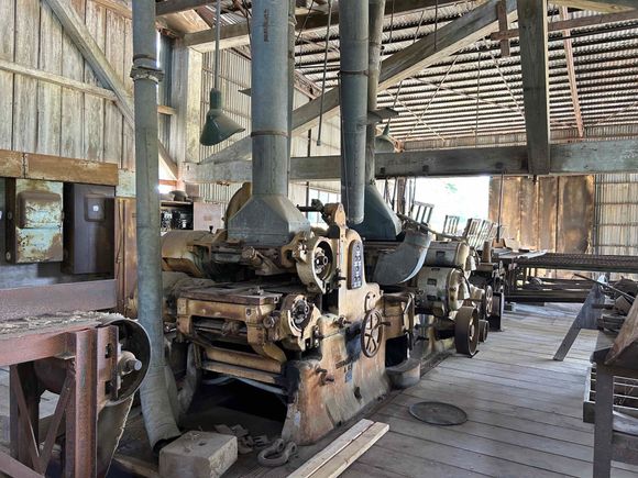 planeing machine. Ran electric from sawdust incinerator next to it. Exposed belt and chain drive. Originally steam?