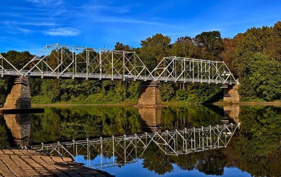 The Dingman's Ferry Bridge is privately owned a toll bridge across the Delaware River.  Pull up and hand the woman, standing between the lanes, two bucks and you are good to go.