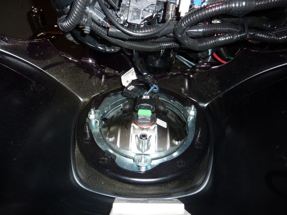 Remove the three fairing screws on the front of the fairing. Tip; Leave the center fairing screw in place until you have removed the windshield.  Pull the fairing way and disconnect the headlight plugs and remove the outer fairing.